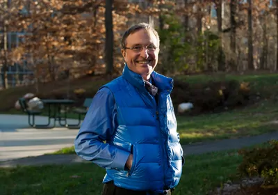 Thomas Lovejoy wearing glasses and smiling at camera